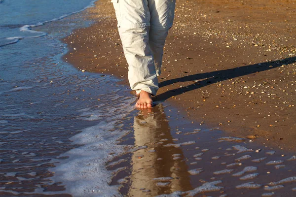 barefoot man walking on the waves of the surf