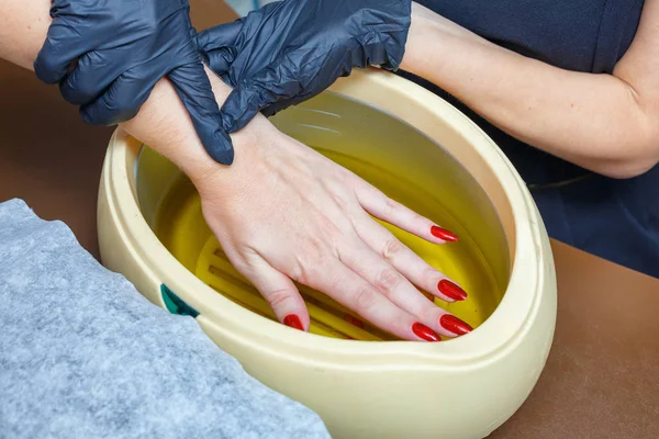 hand care with hot wax, covering with wax, manicure salon.