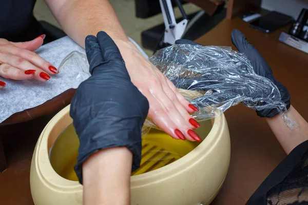hand care with hot wax, covering with wax, manicure salon.