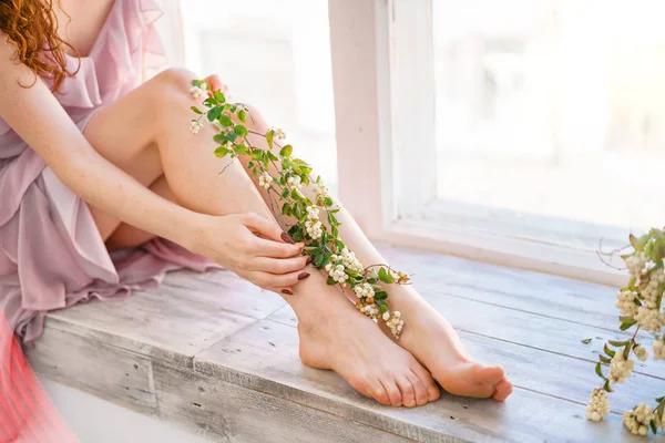 beautiful women's hands and feet with flowers, skin care