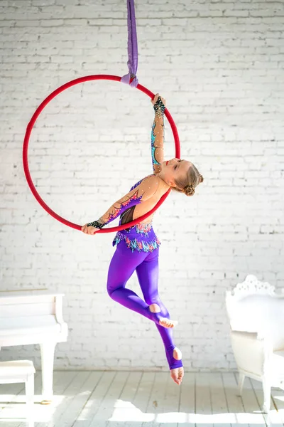 aerial gymnastics on the circle, a little girl doing exercises