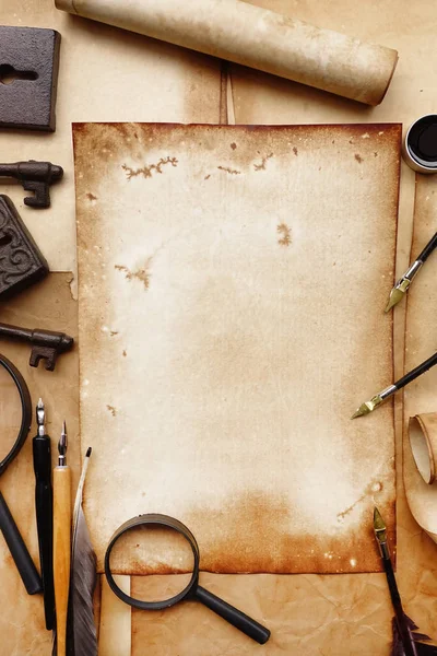 Vintage writing set with old paper on brown wood texture with feather and ink