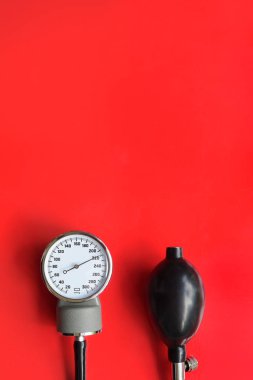 Tansiyon ölçer tıbbi malzeme kırmızı zemin üzerine