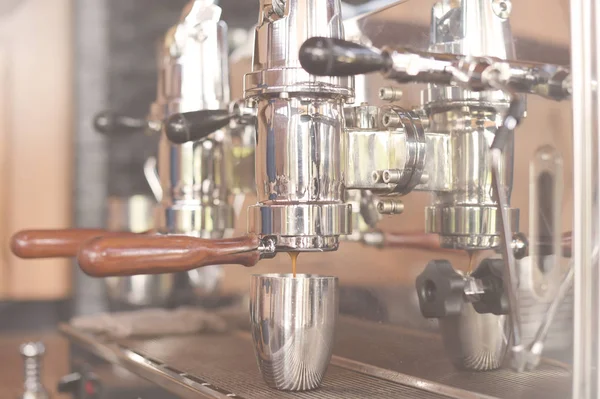 close up of coffee machine preparing cup of coffee