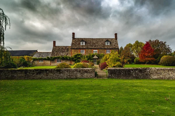 Aged country house under cloudy sky