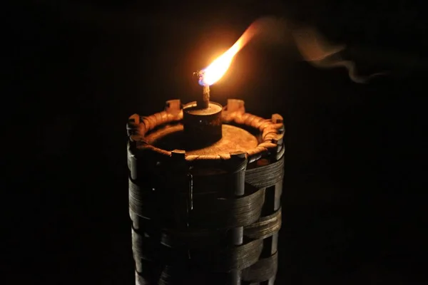 Light the fire on wooden torch in the darkness environment