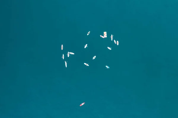 Top view of people surfing in the blue Mediterranean sea