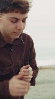 Adam kışın kıyıda dua ederken ağlıyor. .