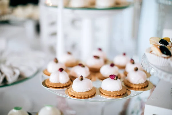 Appetizing sweet white cakes on glass plate