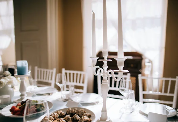 elegant wedding table setting with food and candles