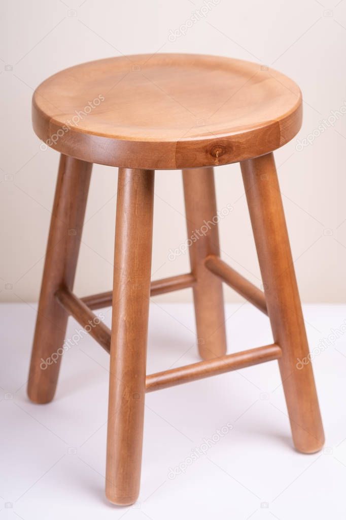 Handcrafted wooden backless stool on white background isolated