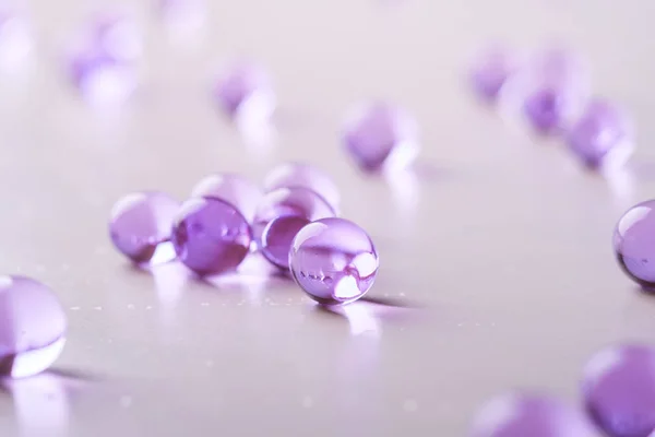 Purple scattered marbles on white background macro