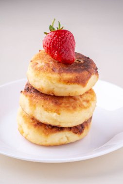 Beyaz tabak izole açı görünümünde bir çilek ile Süzme peynir krep