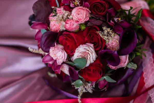 Bridal bouquet of roses, callas and orchids