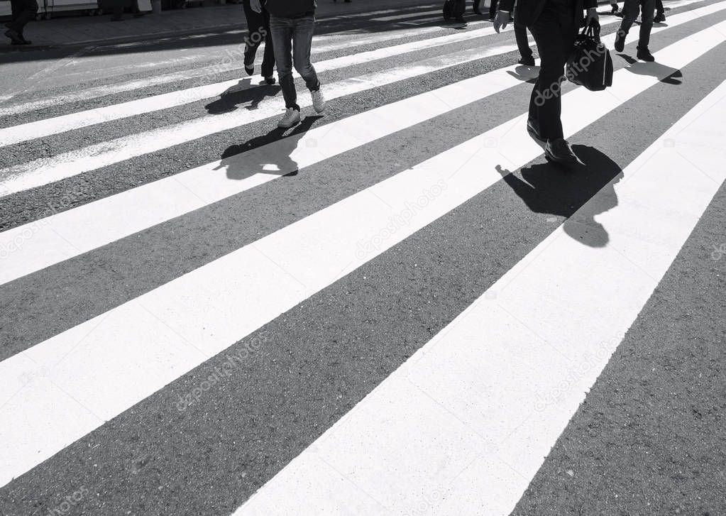 Cross walk with people walking Shadow on urban road traffic Safety sign 