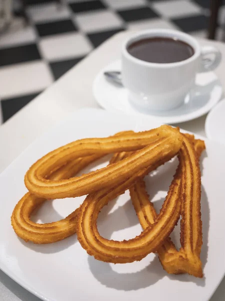 Spanish Churros with cup of hot chocolate traditional dessert