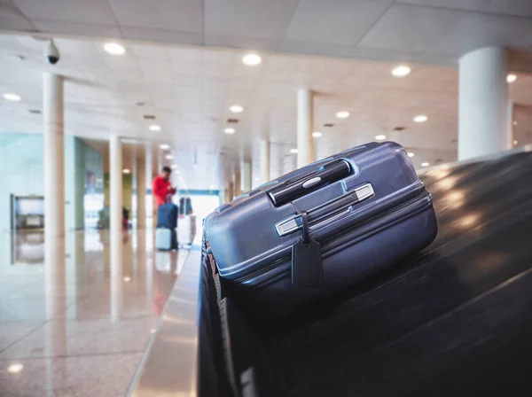 Luggage on Baggage conveyor belt Airport Arrival hall People waiting