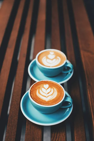 Two Cups Cappuccino Latte Art Wooden Background Beautiful Foam Blue — Stock Photo, Image