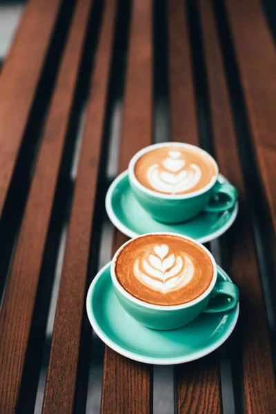 Two Cups Cappuccino Latte Art Wooden Background Beautiful Foam Greenery — Stock Photo, Image