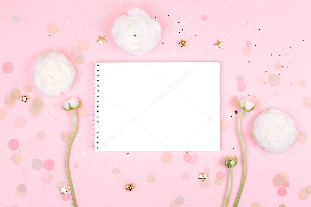 Notebook with flowers on pink pastel background
