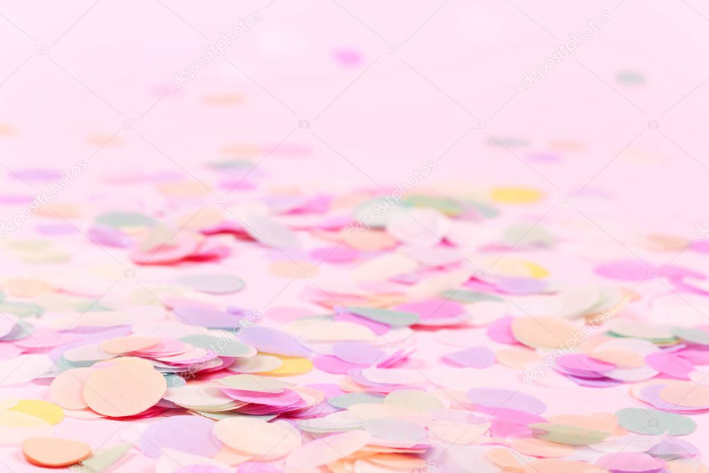 Vibrant confetti on pastel pink background