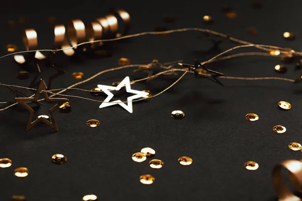 Decoração Dourada Fitas Confetes Guirlanda Estrela Sobre Fundo Preto Foco — Fotografia de Stock