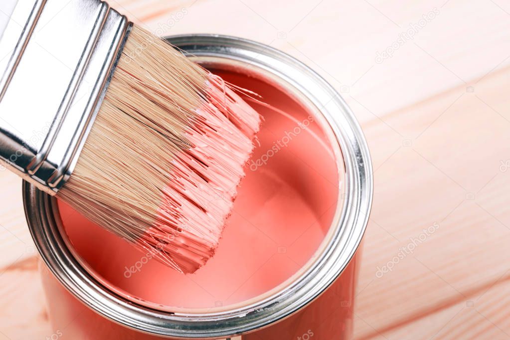 Brush with Living Coral paint on wooden background. Color of the year 2019. Main trend concept.