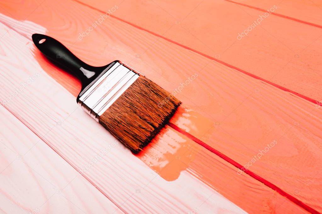 Living Coral fresh painted wooden board. Renovation concept. Top view. Color of the year 2019. Renovation concept.