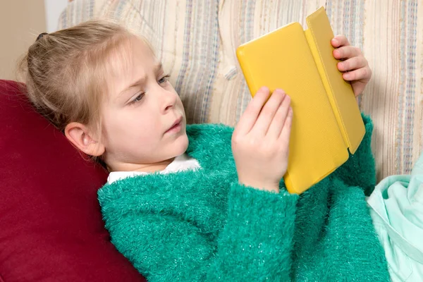 Young Girl Reading Tablet on the Sofa — Stock Photo, Image