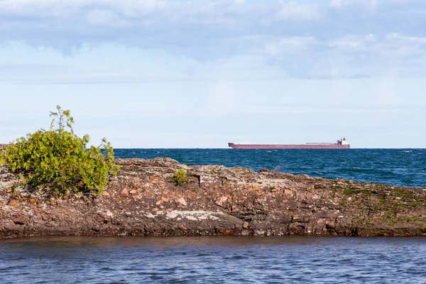 Great Lakes Freighter Passing Behind a Rocky Island — Stock Photo, Image