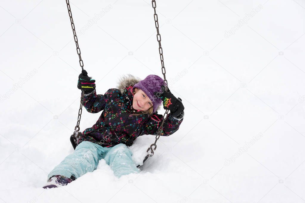 Smiling Girl on Swing in Deep Snow