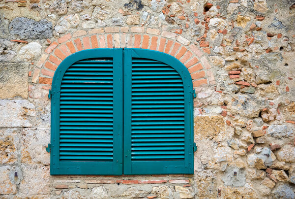 Blue Shutters in an Ancient Tuscan Stone Wall