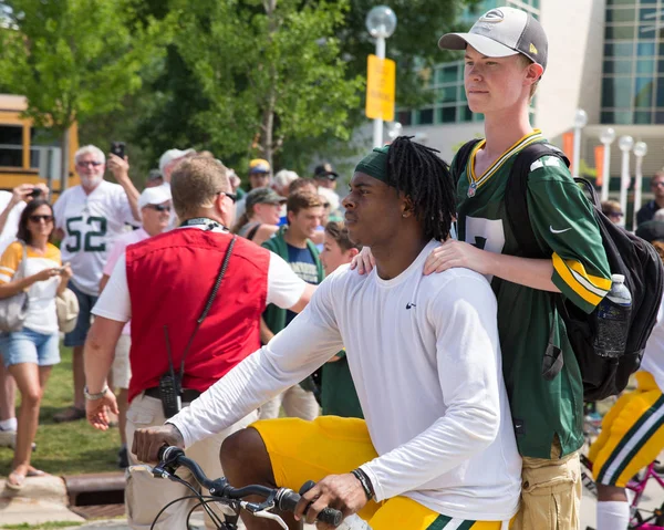 Green Bay Packer Player Riding Bike with Young Fan — Stock Photo, Image