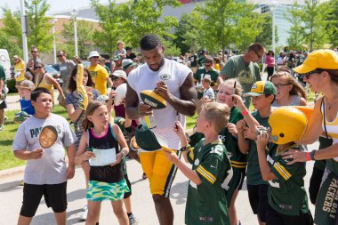 Green Bay Packer Player Signing Autograph for Young Fan clipart