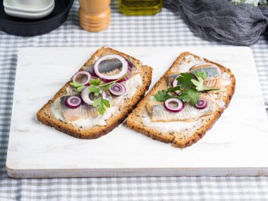 Danish open sandwich smorrebrod with herring clipart