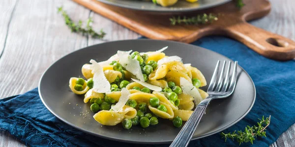 Italian orecchiette pasta with peas and cheese