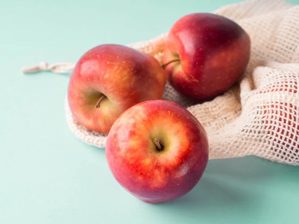 Red apples in reusable cotton bags — Stock Photo, Image