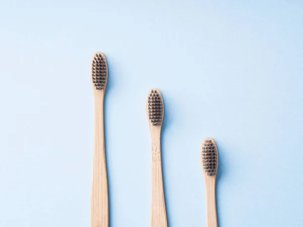 Bamboo biodegradable toothbrushes on blue — Stock Photo, Image