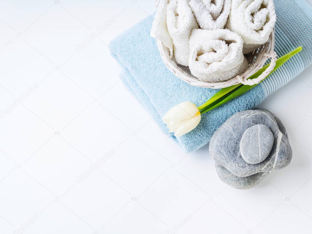 Fresh Towels and stones on white background