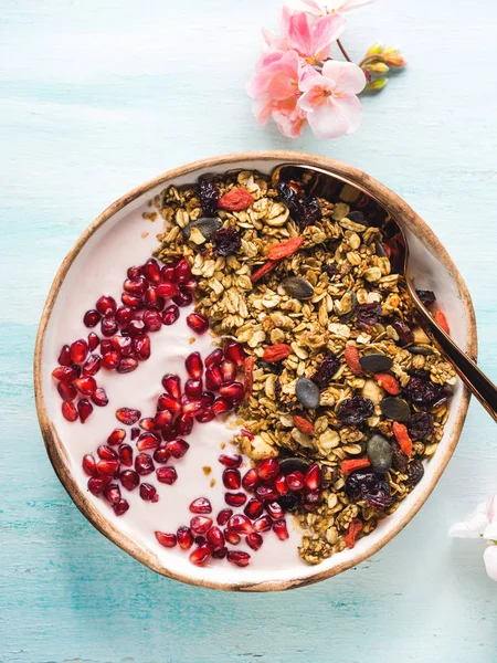 Healthy yogurt bowl with granola and pomegranate