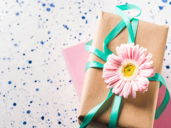 Stacked gift boxes with flowers. Pastel colors