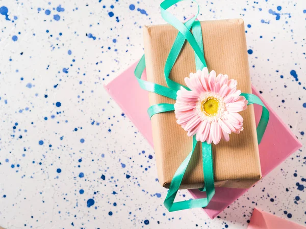 Stacked gift boxes with flowers. Pastel colors