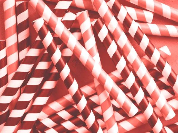 Red and black striped straws. Coral toned — Stock Photo, Image