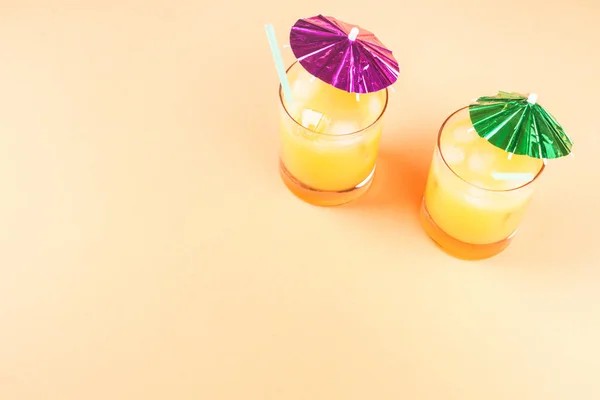 Summer orange ananas cocktails with umbrellas