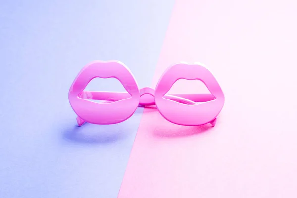 Funky lip shape glasses on pink and sky blue — Stock Photo, Image
