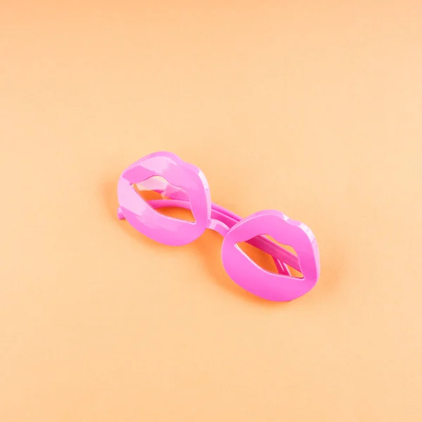 Funky lip shape glasses on orange — Stock Photo, Image