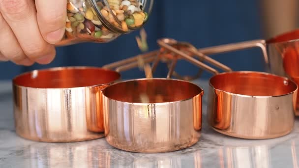 Copper cups on marble. Pouring — Stock Video