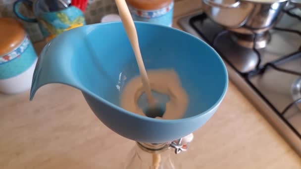 Pouring home made plant milk in a glass bottle — Stock Video