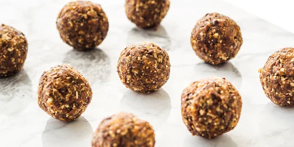 Energy balls with healthy ingredients on marble — Stock Photo, Image