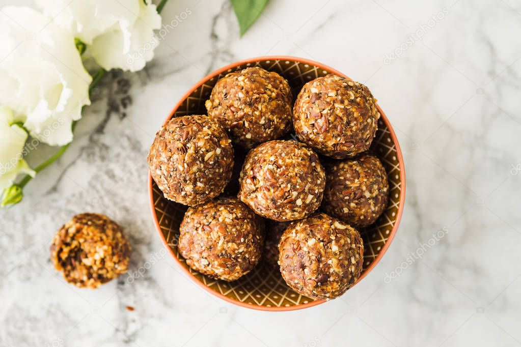 Energy balls with healthy ingredients on marble